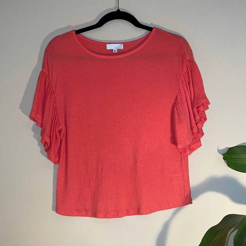 1060 Sherman size small coral colored top with ruffled sleeves